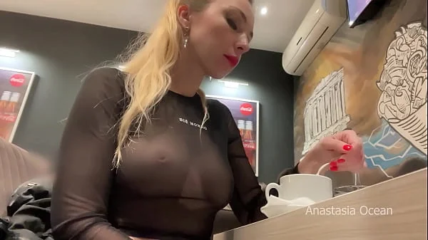 Flashing her big boobs in transparent top in public cafe.
