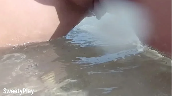 Shaved pussy peeing on public beach