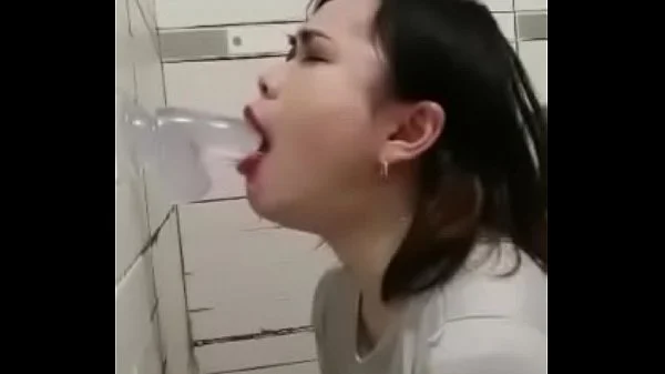 Asian deepthroating a dildo