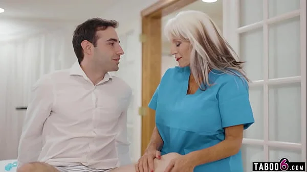 Granny physical therapist Sally DAngelo treats a young handsome client